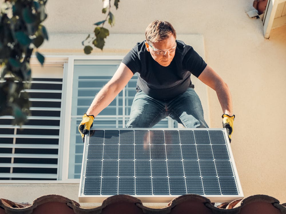 a man holding a solar panel